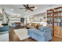 Open-concept living room and dining area with hardwood floors, ceiling fan, and a built-in bookcase at 2031 Audubon Ne Dr, Atlanta, GA 30329