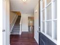 Inviting entryway with hardwood floors, staircase, and a view into the home's open-concept design at 3326 Waldrop Trl, Decatur, GA 30034