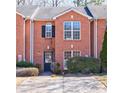 Close-up of brick townhome displaying a well-maintained lawn and convenient private driveway at 3326 Waldrop Trl, Decatur, GA 30034