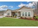 Inviting single-Gathering house showing manicured landscaping, attractive stonework, and a cozy covered porch at 3893 Shelleydale Dr, Powder Springs, GA 30127