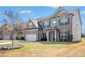 Beautiful two-story brick home with a manicured lawn and a spacious driveway at 4225 Sharpton Park Dr, Auburn, GA 30011