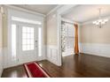 Elegant foyer featuring hardwood floors, a white front door with glass, and a dining area at 4225 Sharpton Park Dr, Auburn, GA 30011