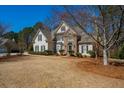 Charming two-story home with manicured landscaping and a combination of siding and stone facade at 4125 Bridle Ridge Dr, Suwanee, GA 30024