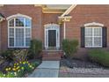Close-up of the front door highlighting the arched windows and beautiful brickwork at 108 Jasmine Way, Villa Rica, GA 30180