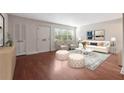 Inviting living room with a plush sofa, decorative ottomans, and hardwood floors at 290 Lakemoore Ne Dr # C, Atlanta, GA 30342