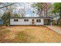 A charming home features a freshly painted white exterior and well-manicured lawn at 1506 Sycamore Nw Dr, Kennesaw, GA 30152