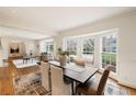 Bright dining room featuring hardwood floors, a large bay window, and elegant decor in an open-concept space at 2374 Havenridge Nw Dr, Atlanta, GA 30305