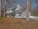 The side of the home features an attached two-car garage, complemented by a well-maintained yard and driveway at 4260 Laurel Glen Ct, Douglasville, GA 30135