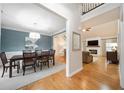 Open concept dining room and living room featuring hardwood floors, stylish furniture, and modern decor at 4910 Hunters Oaks Ln, Alpharetta, GA 30009