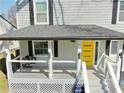 Inviting front porch featuring a porch swing and a bright yellow door, creating a cozy outdoor space at 1560 Sarah M Harden Dr, Atlanta, GA 30311