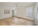 Bright bedroom featuring wood floors, a ceiling fan, and windows with wood trim at 3777 Peachtree Ne Rd # 1007, Atlanta, GA 30319