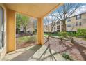 View of courtyard with exterior apartment building and grassy area from covered patio at 3777 Peachtree Ne Rd # 1007, Atlanta, GA 30319
