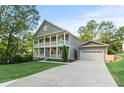 Charming two-story home featuring double porches, a large driveway, and an attached two car garage at 435 Webb Dr, Norcross, GA 30071