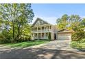 Charming two-story home featuring double porches, a large driveway, and an attached two car garage at 435 Webb Dr, Norcross, GA 30071
