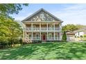 Charming two-story home featuring double porches, a well-manicured lawn, and an attached two car garage at 435 Webb Dr, Norcross, GA 30071