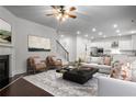 Bright, open living room with fireplace, hardwood floors, and modern decor that connects to the kitchen at 628 Avondale Hills Dr, Decatur, GA 30032