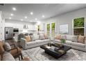 Open living room and kitchen area, featuring hardwood floors, stainless steel appliances, and comfortable seating at 628 Avondale Hills Dr, Decatur, GA 30032