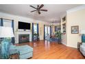 Inviting living room with hardwood floors, fireplace, and seamless access to the dining area at 2520 Cross Springs Dr, Cumming, GA 30041
