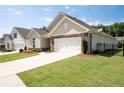 Charming single-Gathering home featuring stone accents, a two-car garage, and a beautifully landscaped front yard at 4902 Pleasantry Way, Acworth, GA 30101