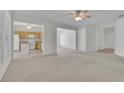 Spacious living room with neutral carpet and open floor plan at 6560 Waveland Dr, Cumming, GA 30040