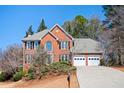 Beautiful two-story brick home with a two-car garage and lovely landscaping at 1439 Evers Pl, Lawrenceville, GA 30043