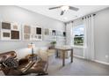 Bright home office with neutral tones, sleek furniture, and natural light from a large window at 2058 Amaryllis Dr, Grayson, GA 30017