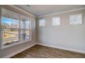 Bright living room featuring large windows and beautiful wood floors at 3870 Ivy Cottage Dr, Snellville, GA 30039