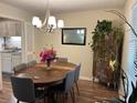 Dining room with wood table, chandelier, and views of the kitchen at 8740 Roswell Rd # 5G, Sandy Springs, GA 30350
