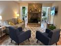 Cozy living room featuring comfortable seating, a stone fireplace, and natural light at 8740 Roswell Rd # 5G, Sandy Springs, GA 30350