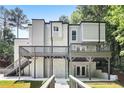 Modern home showcasing a spacious deck, stone accents, and stairs leading to the main entrance at 95 Lakeshore Ne Cir, Marietta, GA 30067