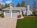 Charming gray home with a two-car garage, stone accents, and manicured lawn at 207 Bent Oak Ln, Woodstock, GA 30189