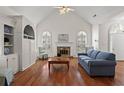 Bright living room with vaulted ceiling, fireplace, hardwood floors, and built-in shelving at 207 Bent Oak Ln, Woodstock, GA 30189