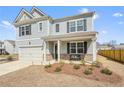 Charming two-story home featuring a welcoming front porch and a well-manicured lawn at 288 Highgrove Way, Dallas, GA 30157