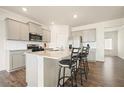 Modern kitchen with granite countertops, stainless steel appliances, and a stylish island with barstool seating at 288 Highgrove Way, Dallas, GA 30157