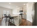 Modern kitchen with granite countertops, stainless steel appliances, and a stylish island with barstool seating at 288 Highgrove Way, Dallas, GA 30157