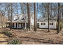 Charming two-story home with dormer windows, covered porch, and mature trees in a quiet setting at 3780 Clubview Se Ct, Conyers, GA 30094