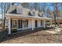 Charming front porch view with rocking chairs, porch swing, and meticulous landscaping at 3780 Clubview Se Ct, Conyers, GA 30094