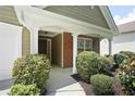 View of covered porch with brick columns and walkway leading to the home's entrance at 8237 Eastshore Dr, Union City, GA 30291