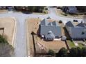 An aerial view of the backyard of a home showing its landscaping and the surrounding neighborhood at 942 Fairmont Park Dr, Dacula, GA 30019