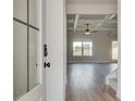 Open-concept living room with coffered ceilings and abundant natural light is seen through the front door at 4604 Eastbrook Pl, Snellville, GA 30039