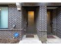 Brick entryway showcasing modern door with sidelight, protected by an ADT security system at 77 Krog Ne St, Atlanta, GA 30307