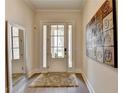 Light and airy entryway with hardwood floors and a decorative mirror at 112 Calder Dr, Alpharetta, GA 30009