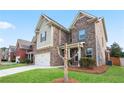 Two-story home featuring brick and siding, with a well-kept lawn at 2471 Arnold Palmer Way, Duluth, GA 30096