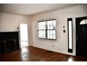 Cozy living room featuring a black brick fireplace, hardwood floors, a front door and natural light at 2642 Joyce Ave, Decatur, GA 30032