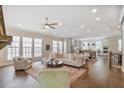 Spacious living room with hardwood floors and many windows offering ample natural light at 385 Rowes Cir, Alpharetta, GA 30009