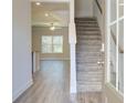 Bright entryway with wood floors, staircase, and view of the living area with large windows at 4594 Eastbrook Pl, Snellville, GA 30039