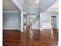 Bright living room featuring hardwood floors, a staircase, and large windows with abundant natural light at 1761 Brandemere Dr, Austell, GA 30168