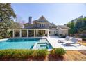 Backyard oasis featuring a large swimming pool, spa, covered patio, and lounge area for relaxation at 479 Argonne Nw Dr, Atlanta, GA 30305