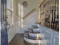 Entryway with decorative staircase, hardwood floors, natural light and wainscoting at 401 Iona Abbey Se Ct # 6, Smyrna, GA 30082