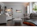 Living room featuring dark hardwood floors, grey walls, stylish furniture and built-in bookshelves at 401 Iona Abbey Se Ct # 6, Smyrna, GA 30082